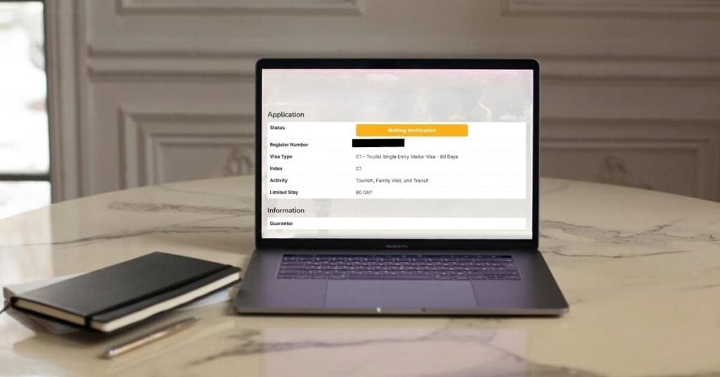 Reisende schaut frustriert auf ihren Computer – Indonesien Visumantrag hängt im Status Waiting Verification fest.